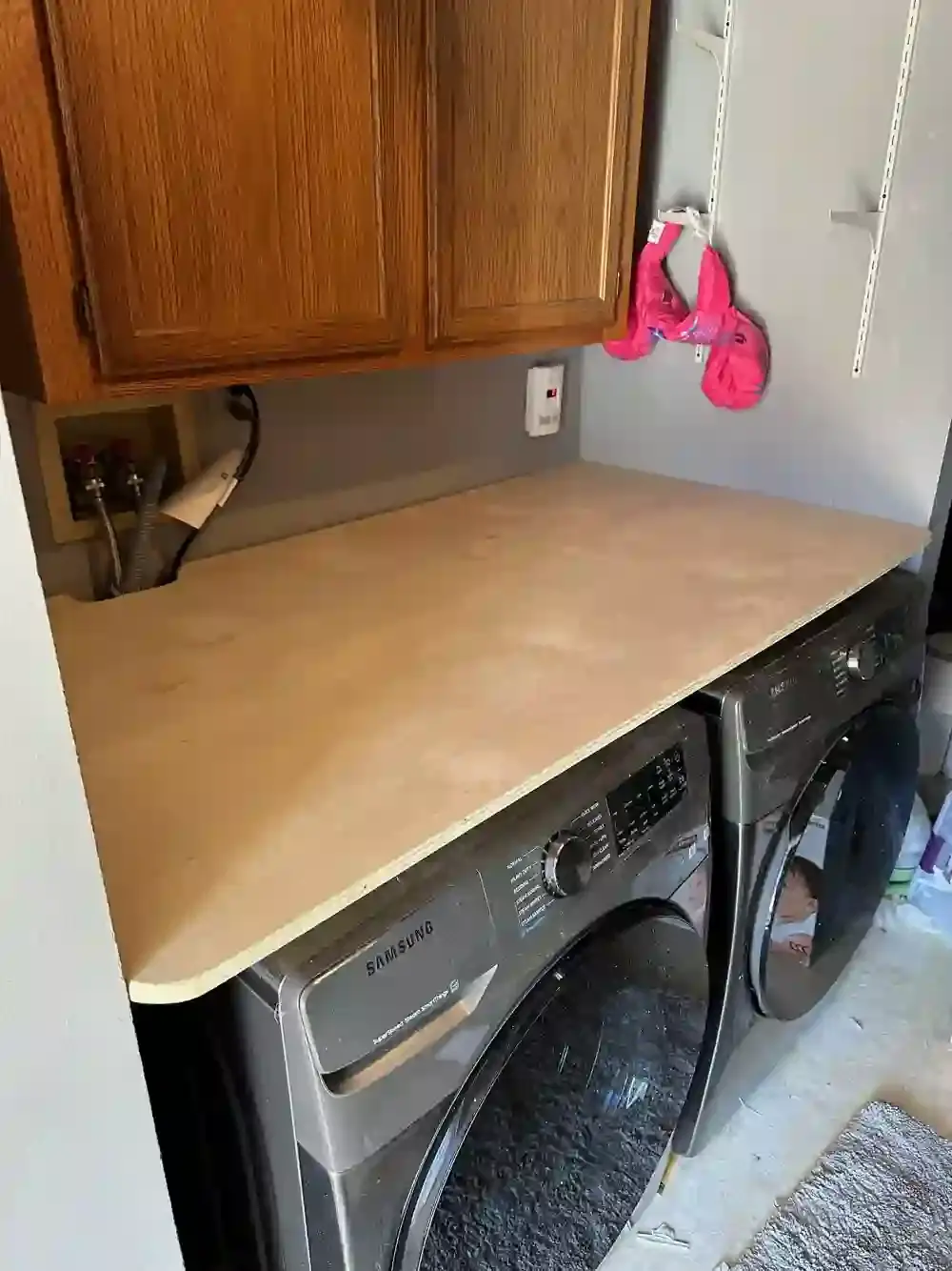 Custom shelf installed above laundry machines